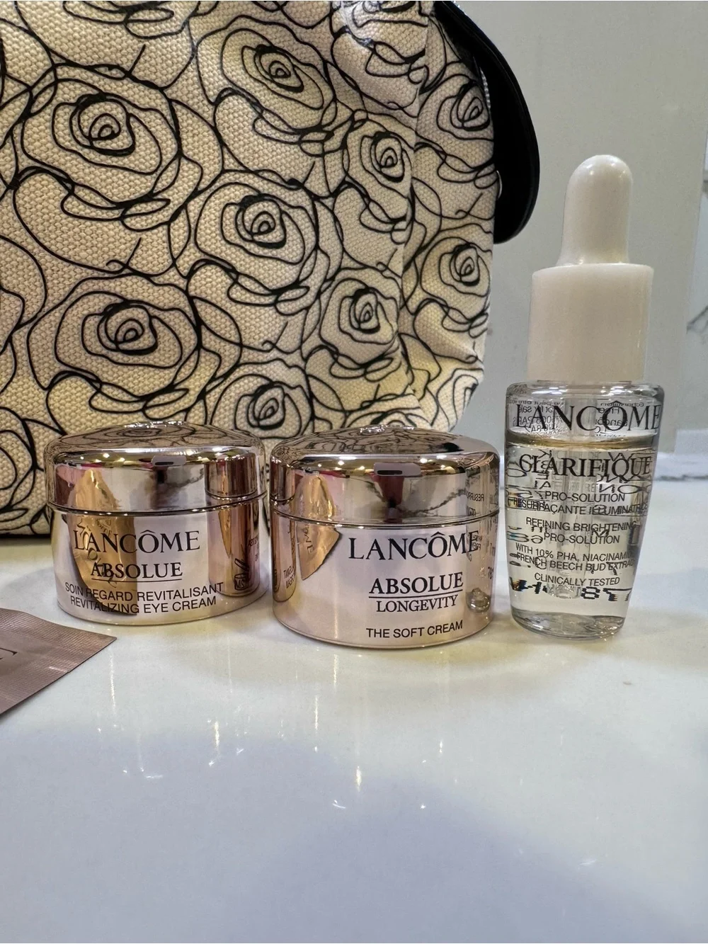 NWOT Lancome Floral Canvas Cosmetic Bag in Cream and Black with skincare minis